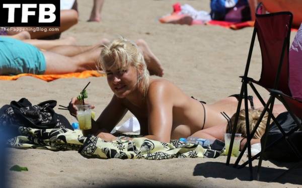 Sarah Connor Flashes Her Nude Breasts on the Beach on www.modeladdicts.com
