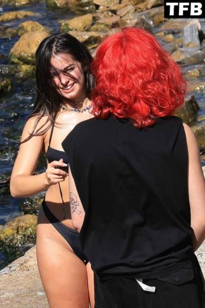 Addison Rae Displays Her Curves in a Black Bikini on Holiday with Omer Fedi on Lake Como on modeladdicts.com
