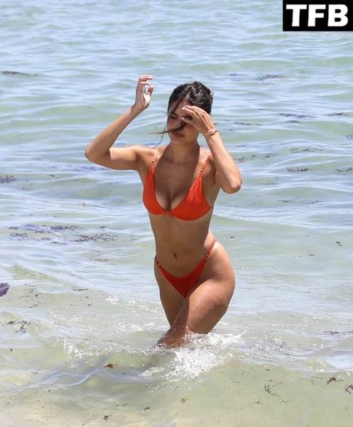 Tao Wickrath Stuns in Small Orange Bikini on the Beach in Miami - county Miami on modeladdicts.com