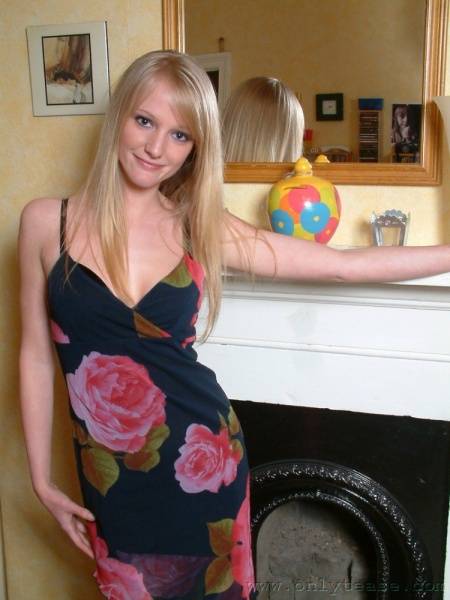 Nice Blonde Chickie Sharon Posing In Dress And Lingerie By The Fireplace photos (Sharon Onlytease) on www.modeladdicts.com